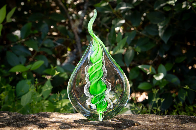 glass flame with cremation ash from pets and people
